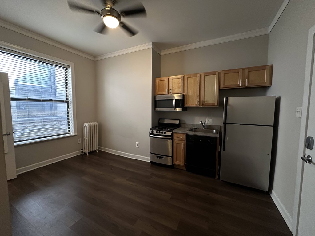 A kitchen with a refrigerator, stove, and oven.