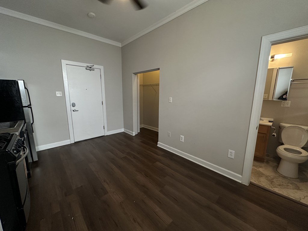 A kitchen with a stove top oven and a white door.