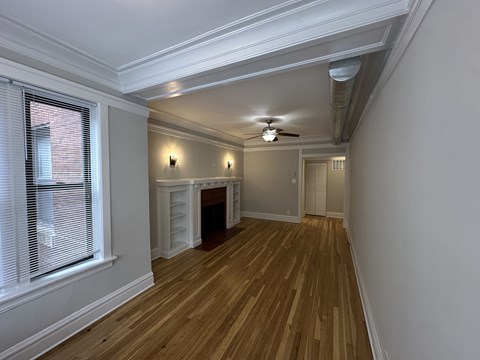 A room with wooden floors and a fireplace.