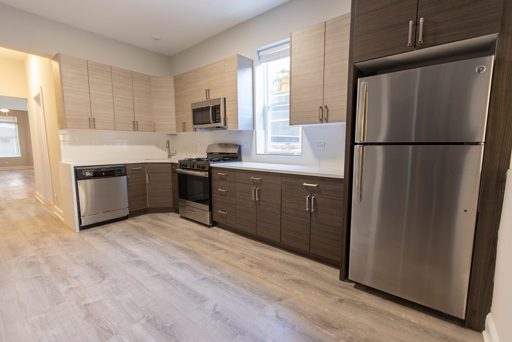 A modern kitchen with a refrigerator on the right.