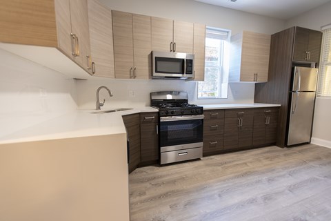 A kitchen with a stove top oven and a microwave above it.