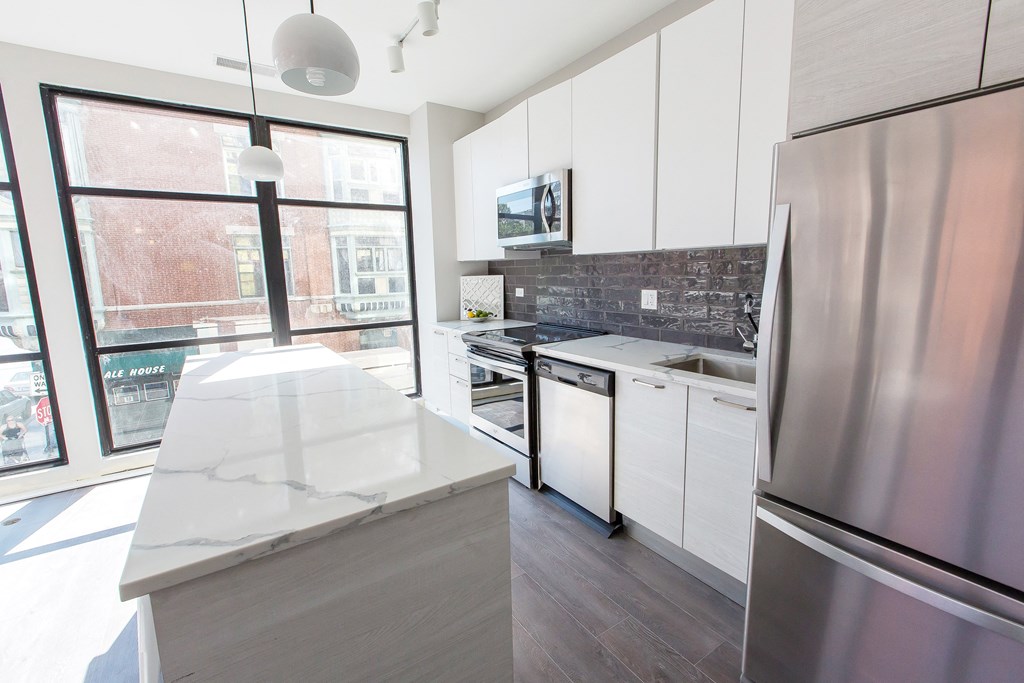 a kitchen with stainless steel appliances and a large window
