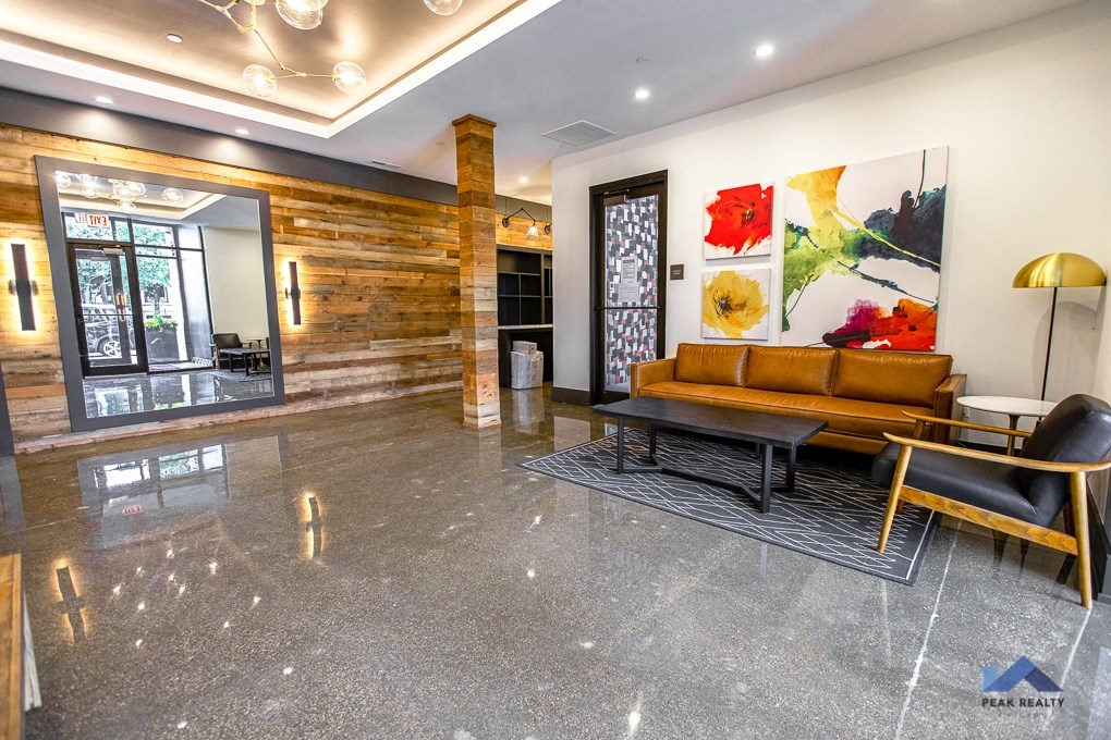 a lobby with a couch and a painting on the wall