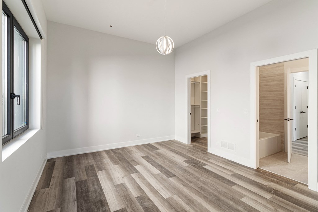 a living room with white walls and wood flooring