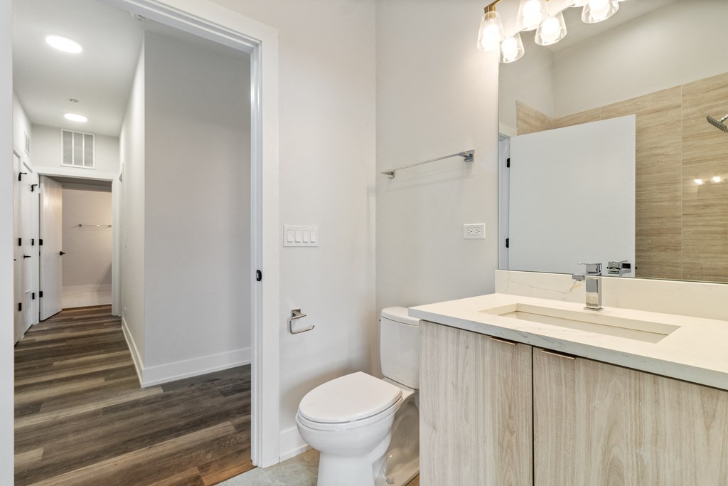 a bathroom with a toilet and a sink and a mirror