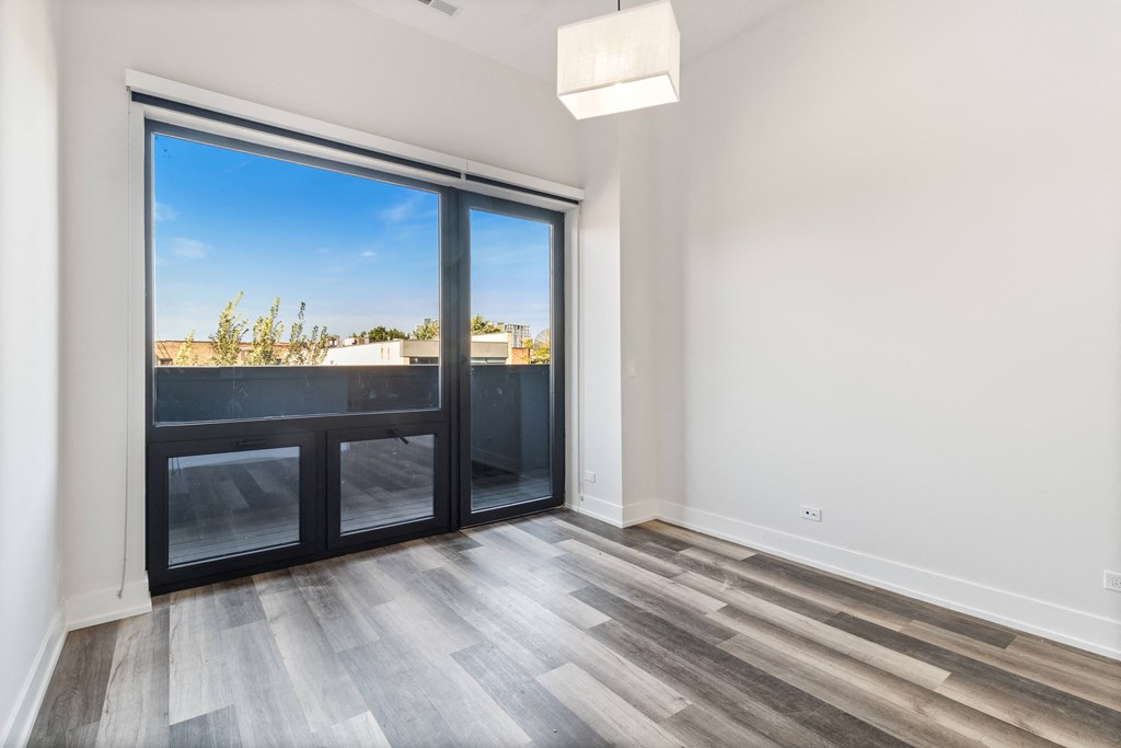 a living room with a sliding glass door and a balcony