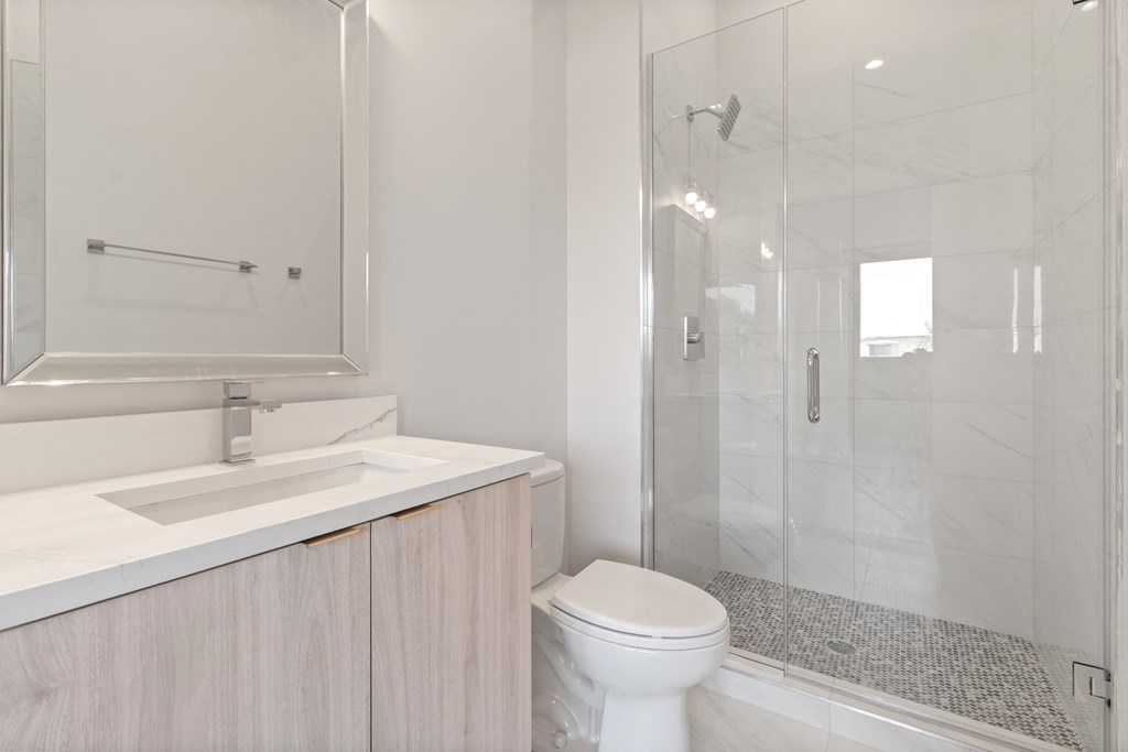 a bathroom with a shower sink and toilet