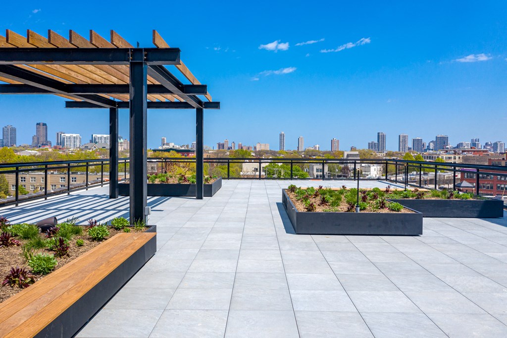 a roof terrace with benches and a view of the city