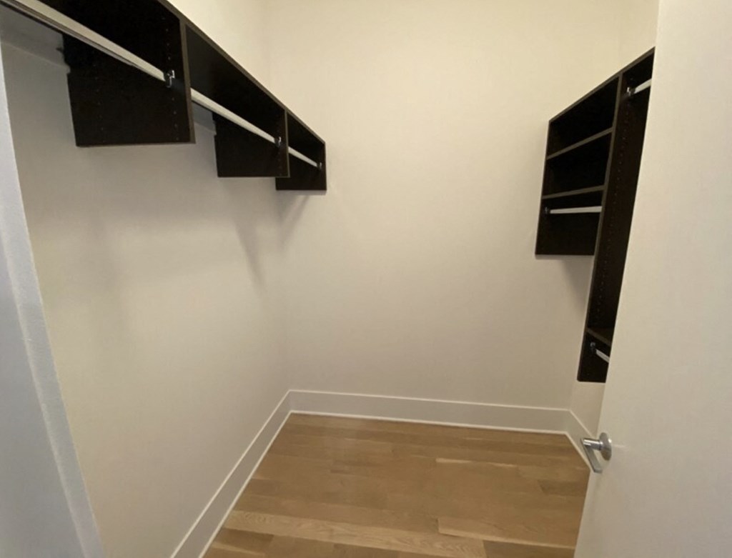 a room with three hanging shelves on the wall
