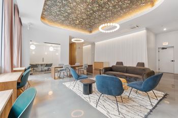 a seating area with a couch chairs and tables