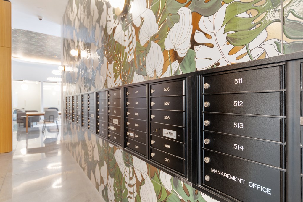 a row of mailboxes on a wall with a floral wallpaper