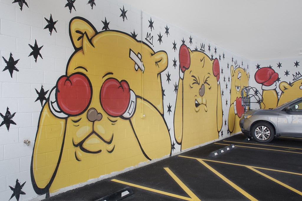 a mural of pooh and his friends in a parking lot