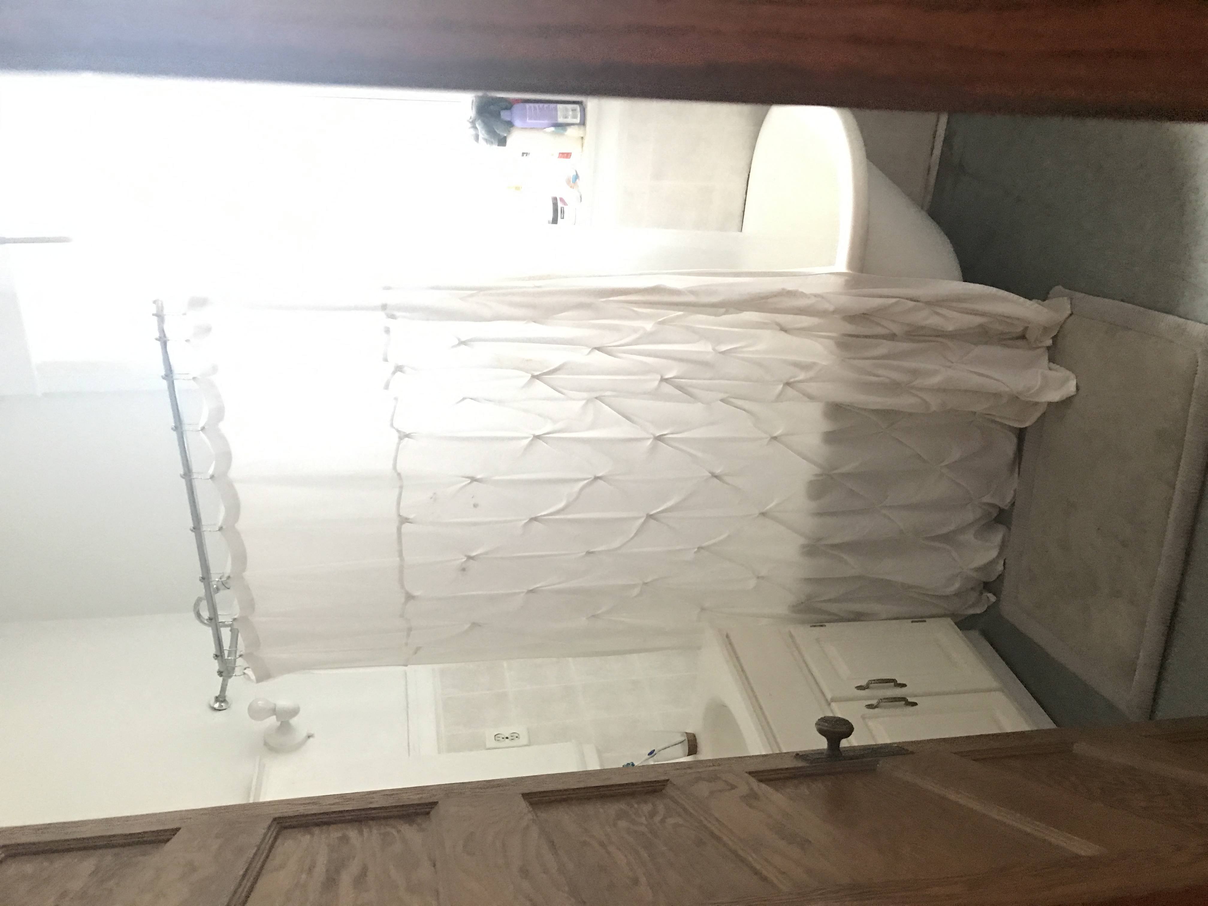 a stack of paper towels in a bathroom with a window