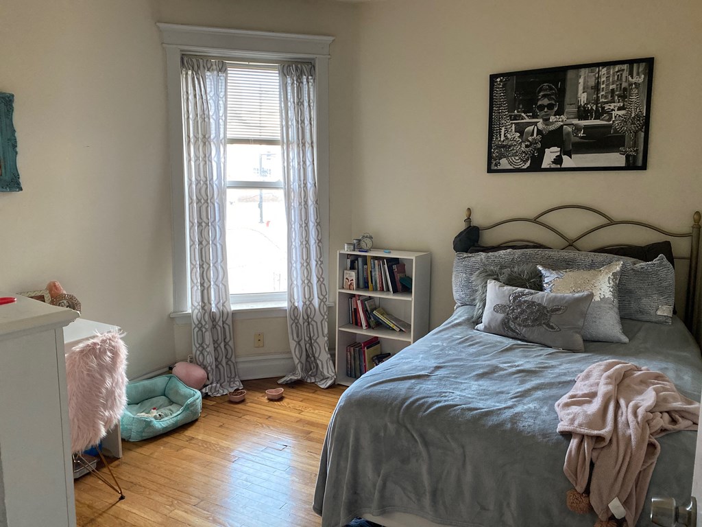 a bedroom with a bed and a window
