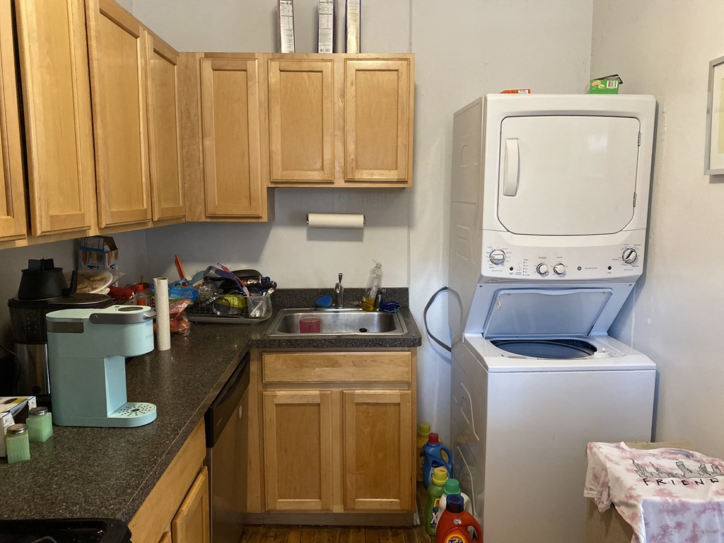 a kitchen with a washer and dryer in it