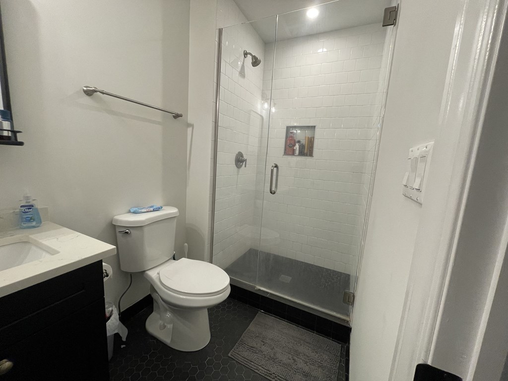 a small bathroom with a shower and a toilet