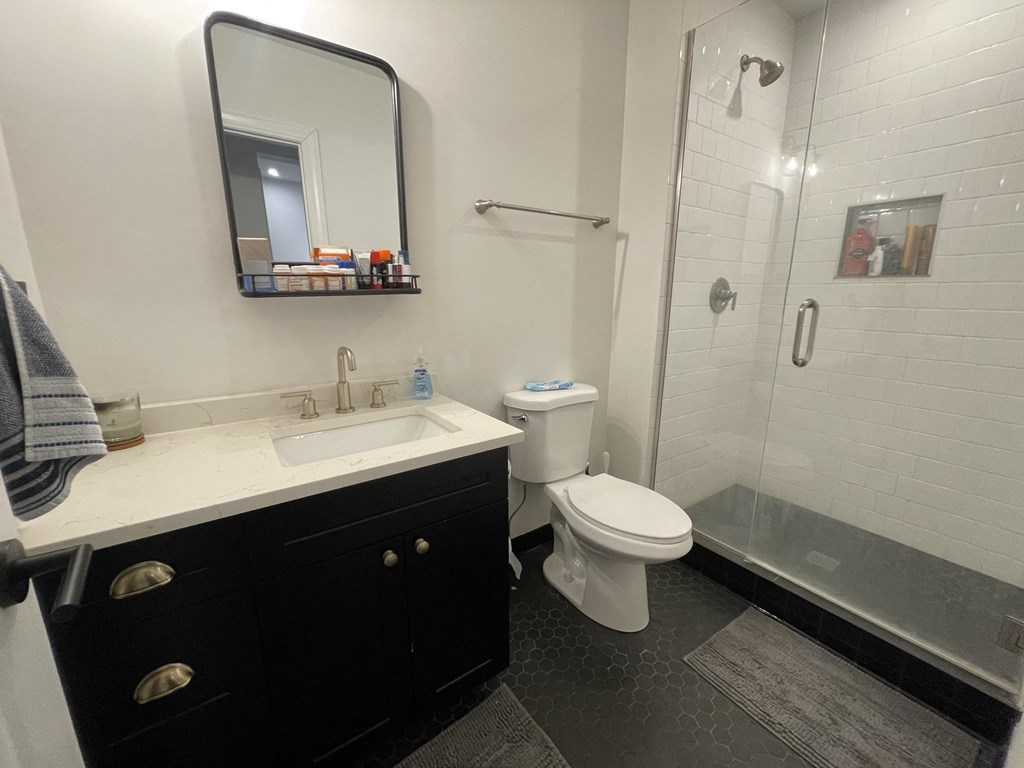 a bathroom with a sink toilet and shower