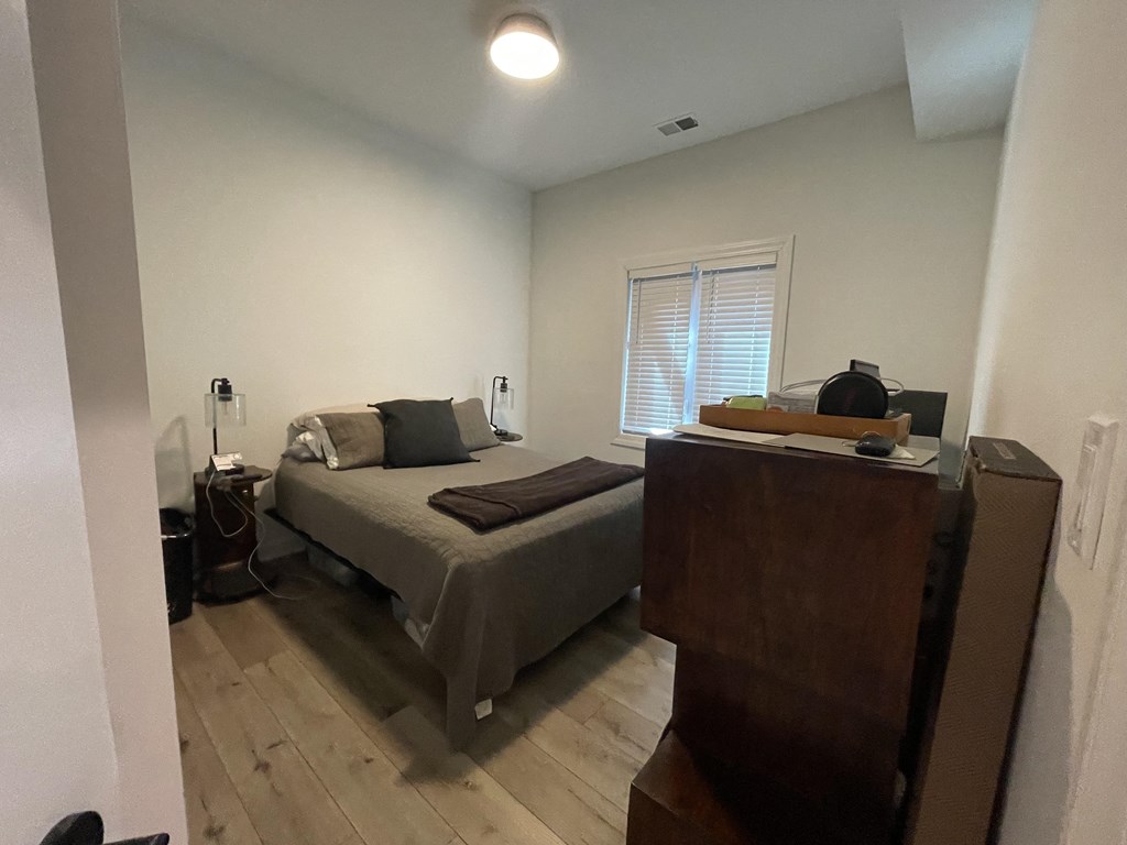 a small bedroom with a bed and a dresser