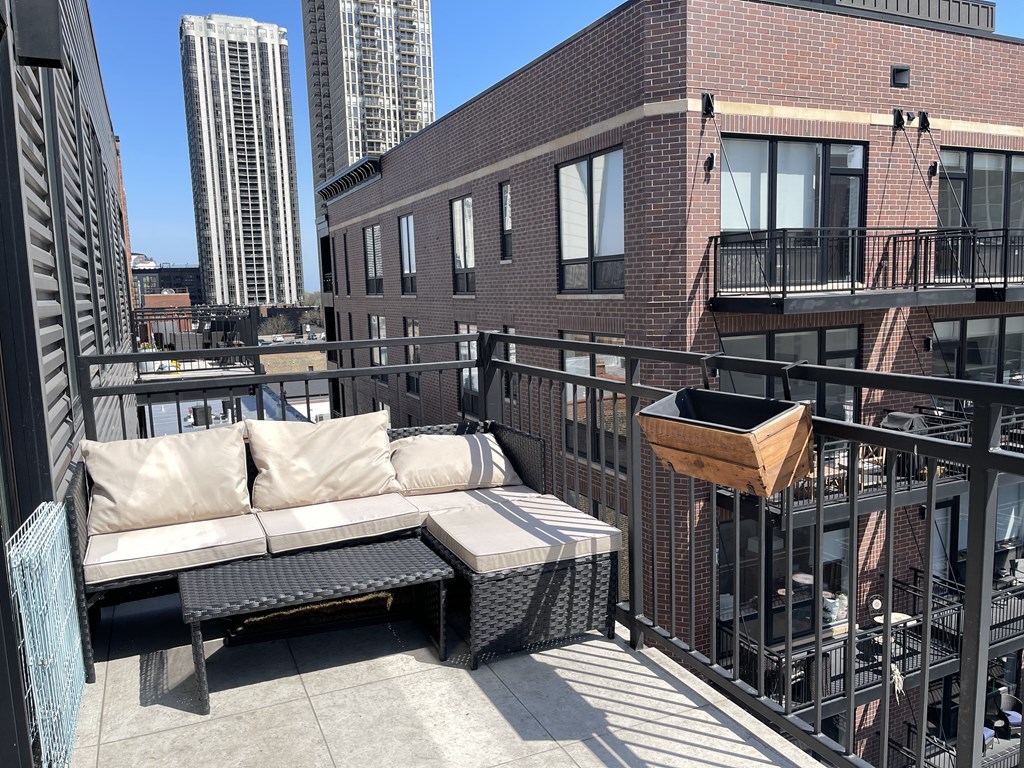 a balcony with a couch and a table on it
