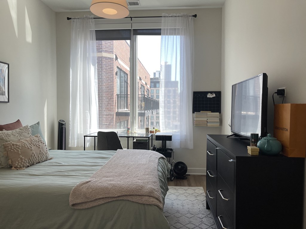 a bedroom with a bed and a tv in a room