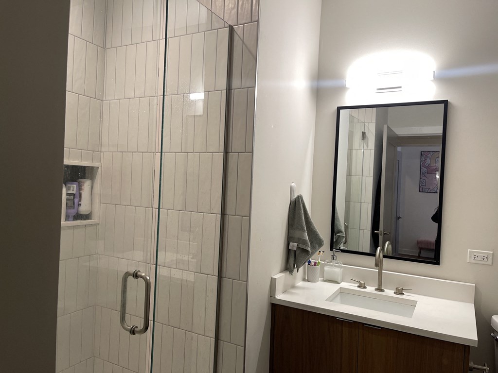 a bathroom with a shower and a sink