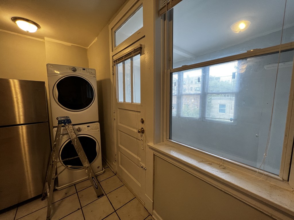 a laundry room with a washer and dryer next to a window