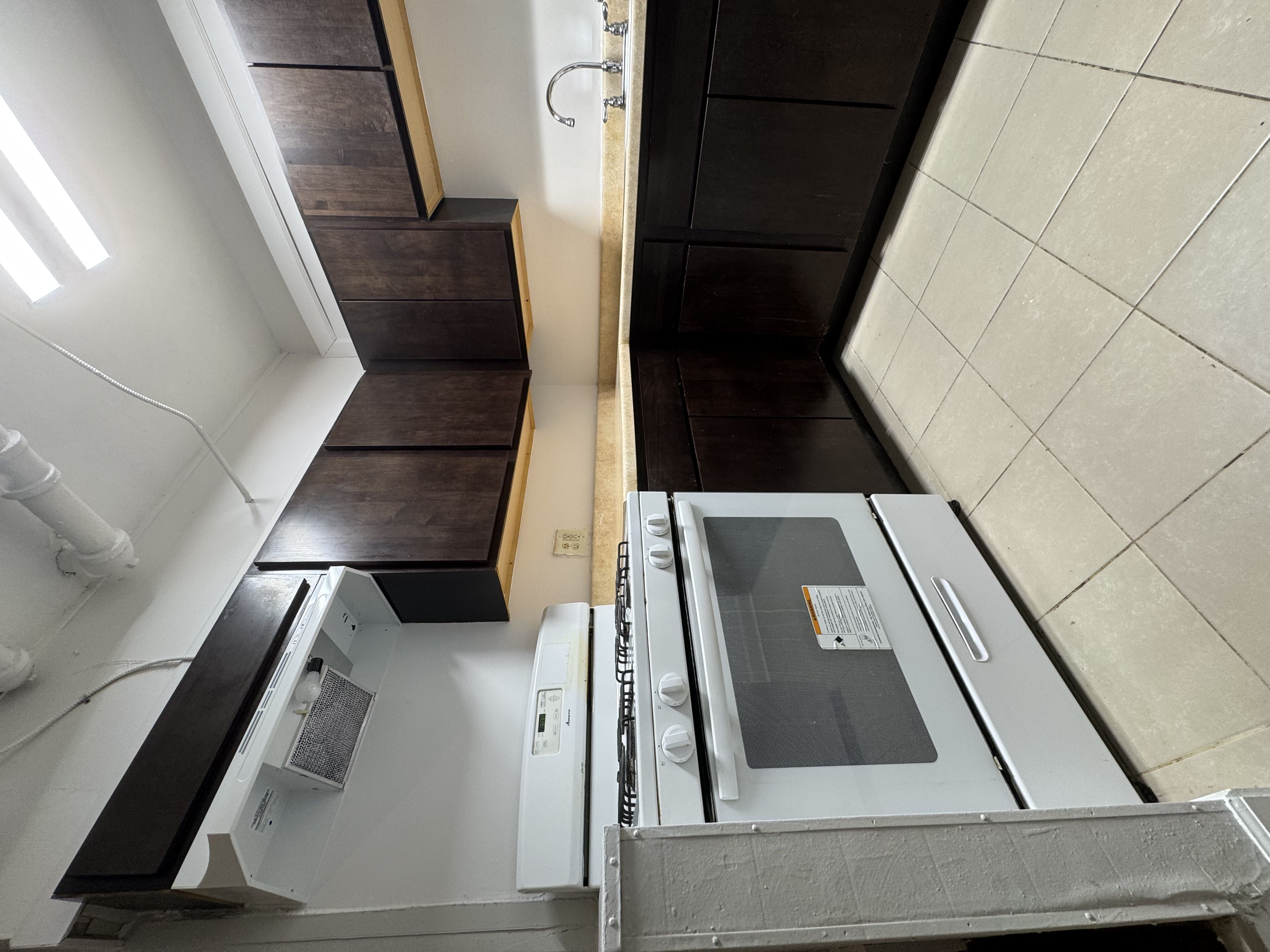 A stainless steel oven with a glass door is in the foreground of the image.