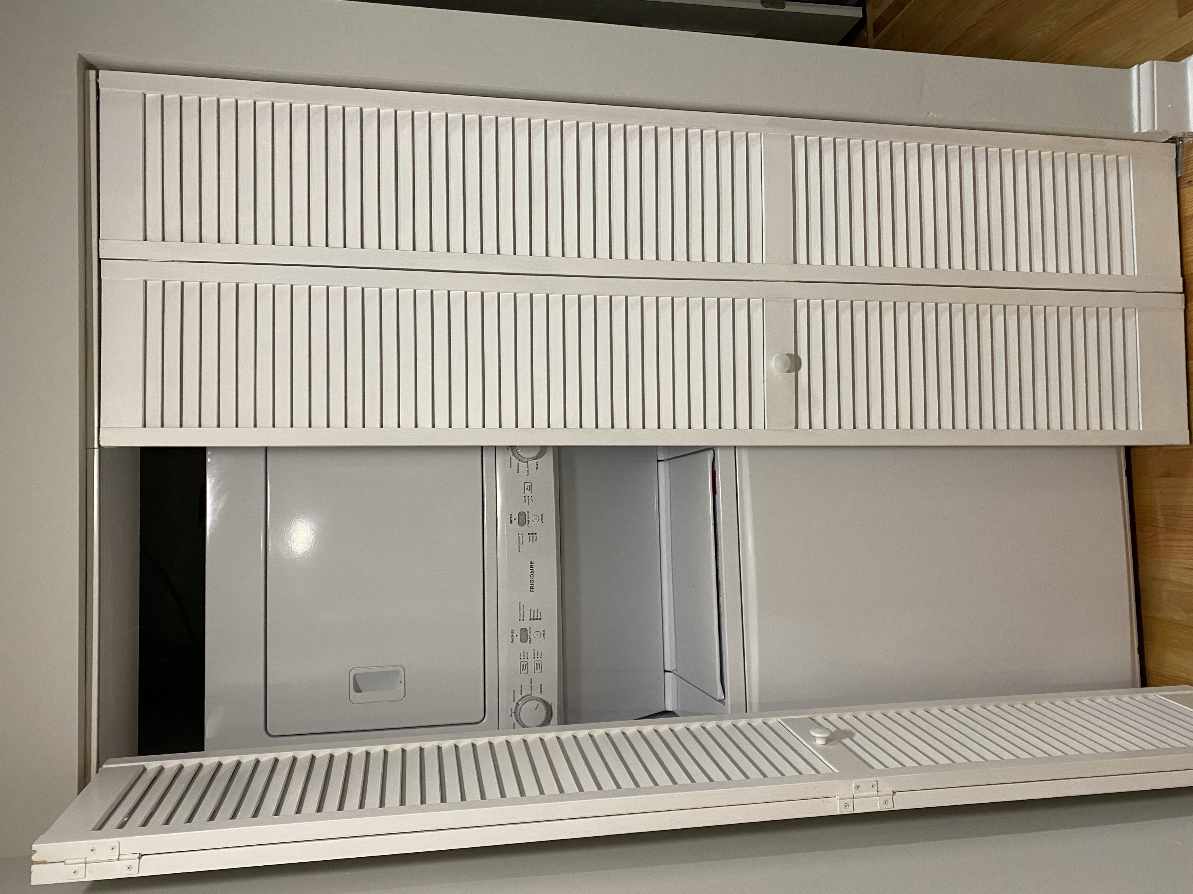 A microwave oven is placed on a shelf.