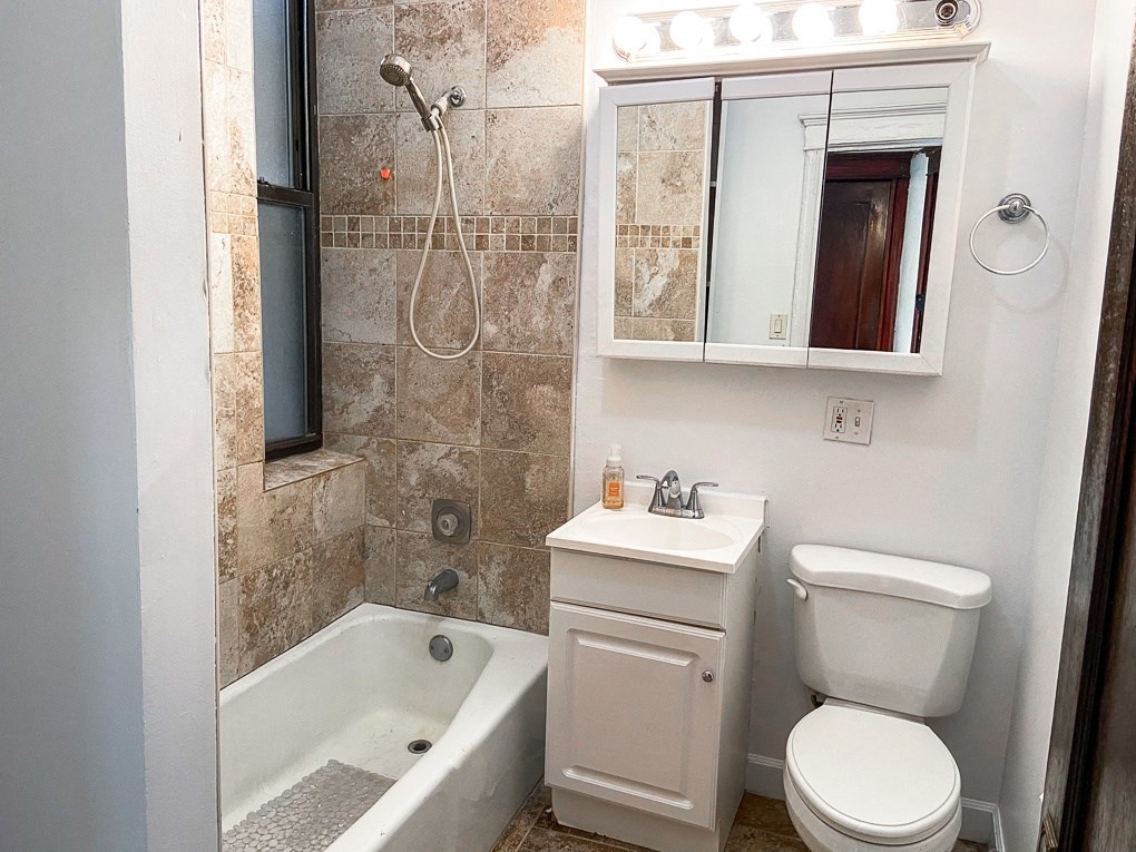 a bathroom with a toilet sink and bathtub