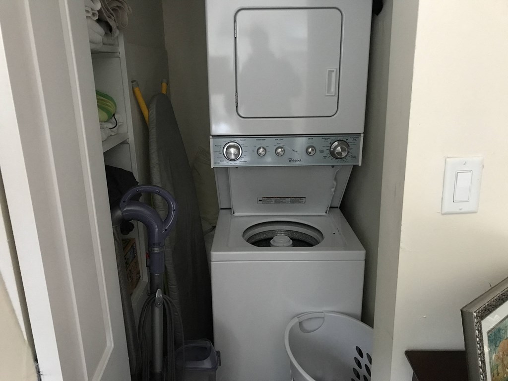 the washer and dryer in the bathroom of a small house