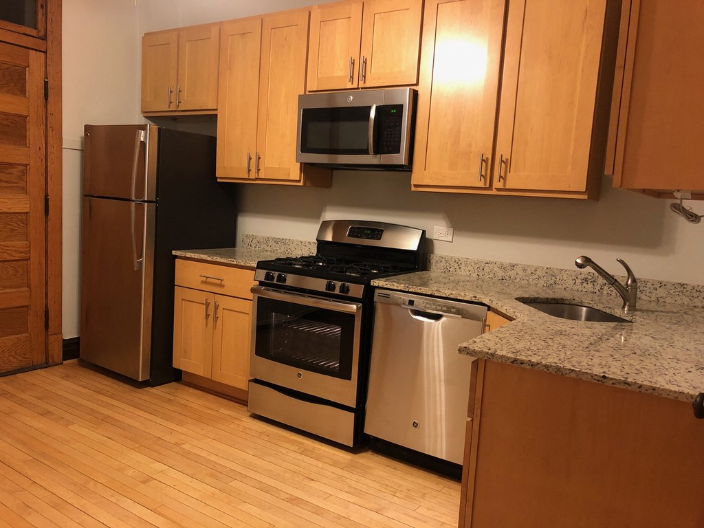 a kitchen with stainless steel appliances and wooden cabinets