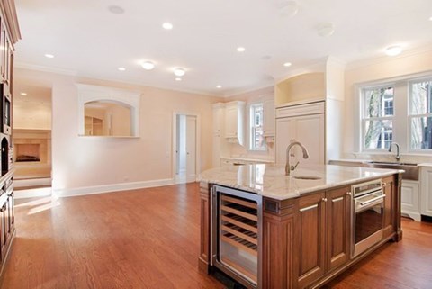 A kitchen with wooden cabinets and a large island.