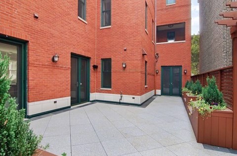 A courtyard surrounded by red brick buildings.