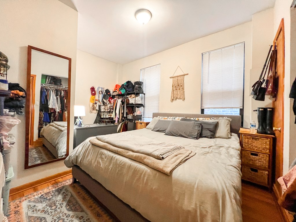 a bedroom with a bed and a mirror and a closet