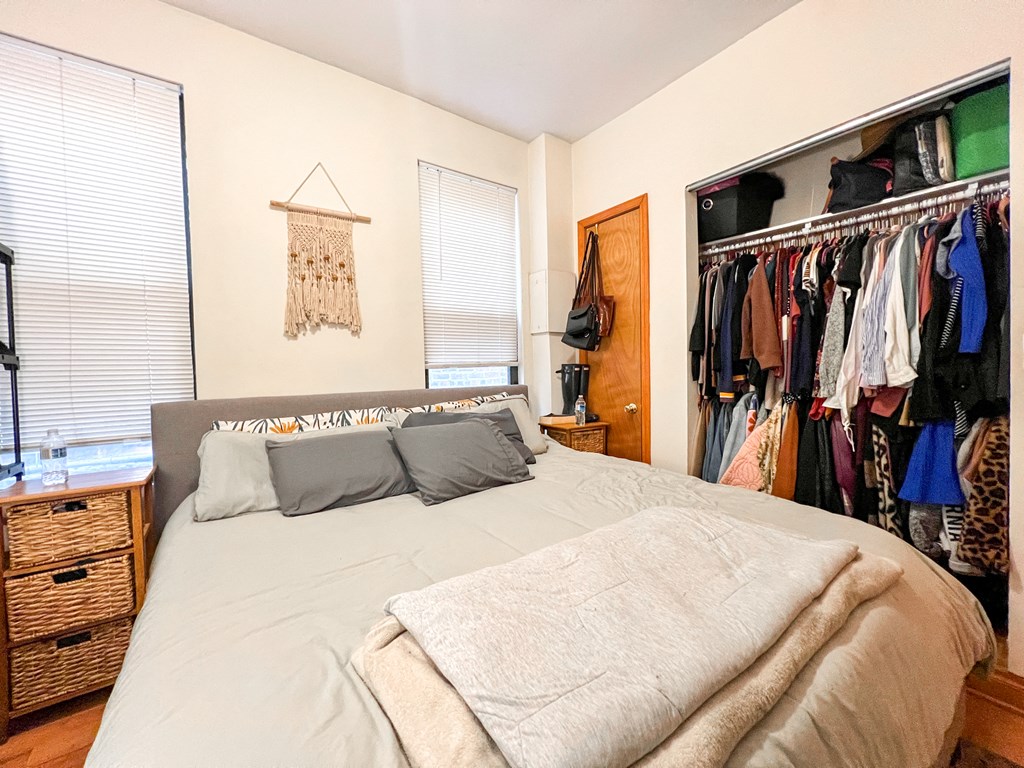 a bedroom with a large bed and a closet