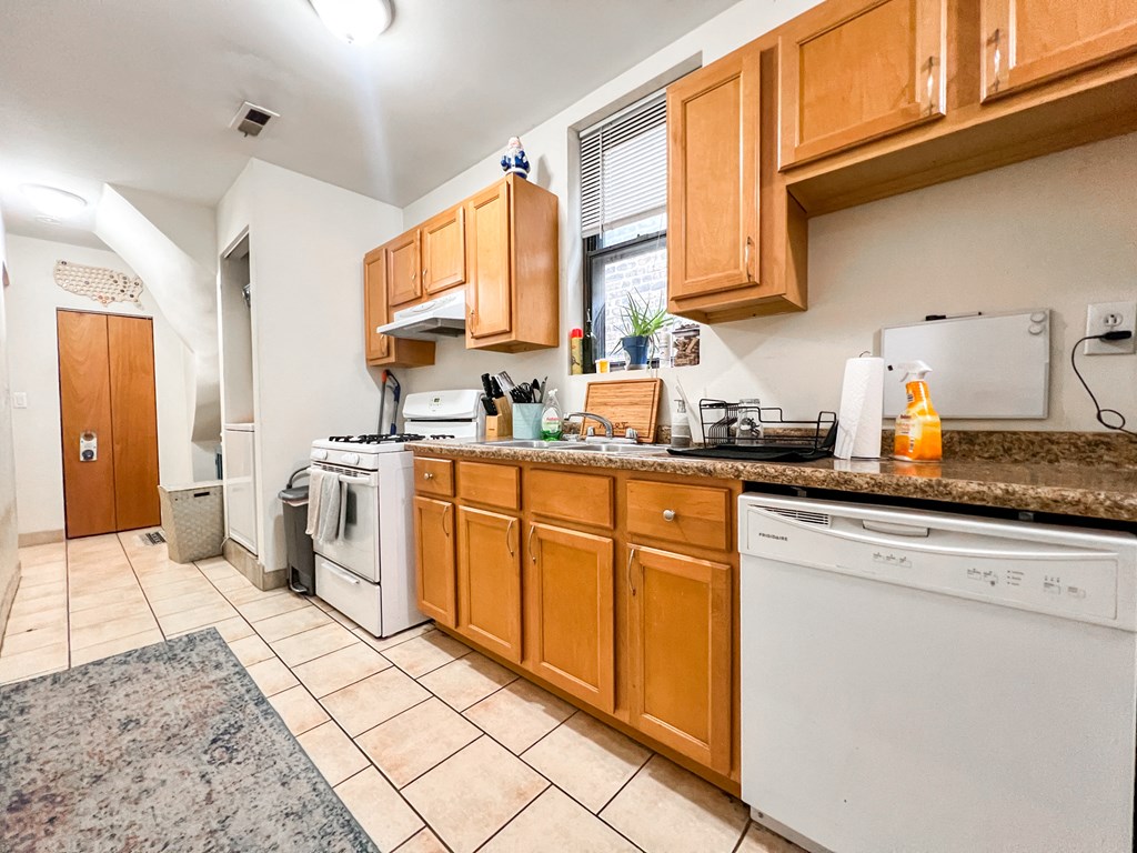 the kitchen is equipped with a dishwasher stove and refrigerator and a sink