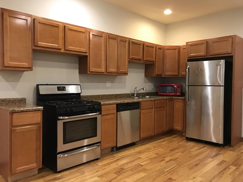 A kitchen with wooden cabinets and stainless steel appliances.