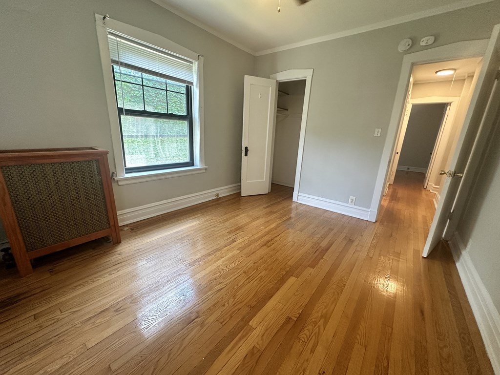 a living room with a hard wood floor and a large window