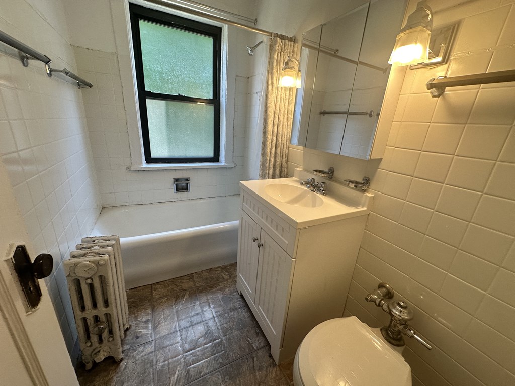 a bathroom with a sink toilet and a tub