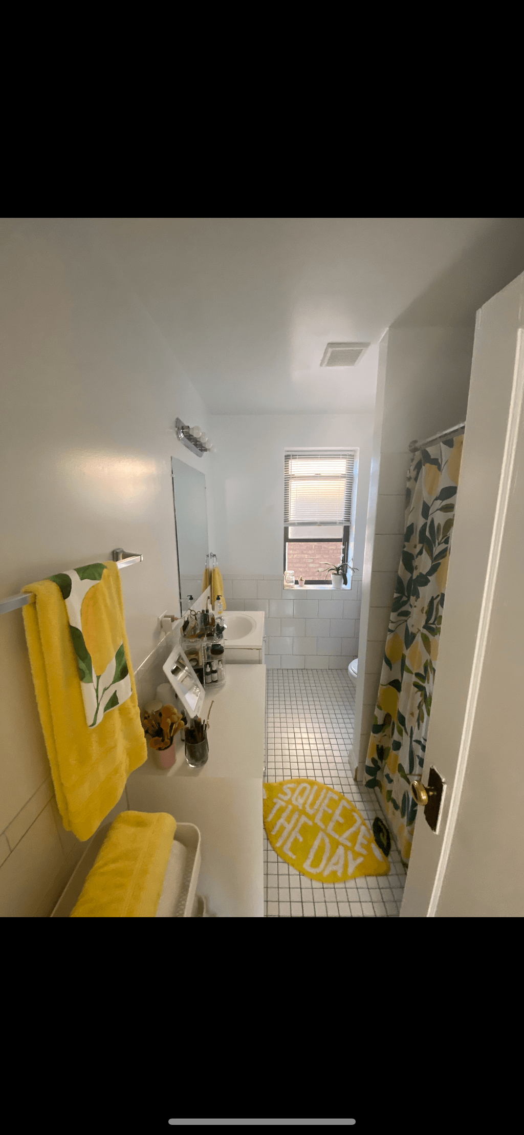 a bathroom with a yellow shower curtain and a toilet and a sink