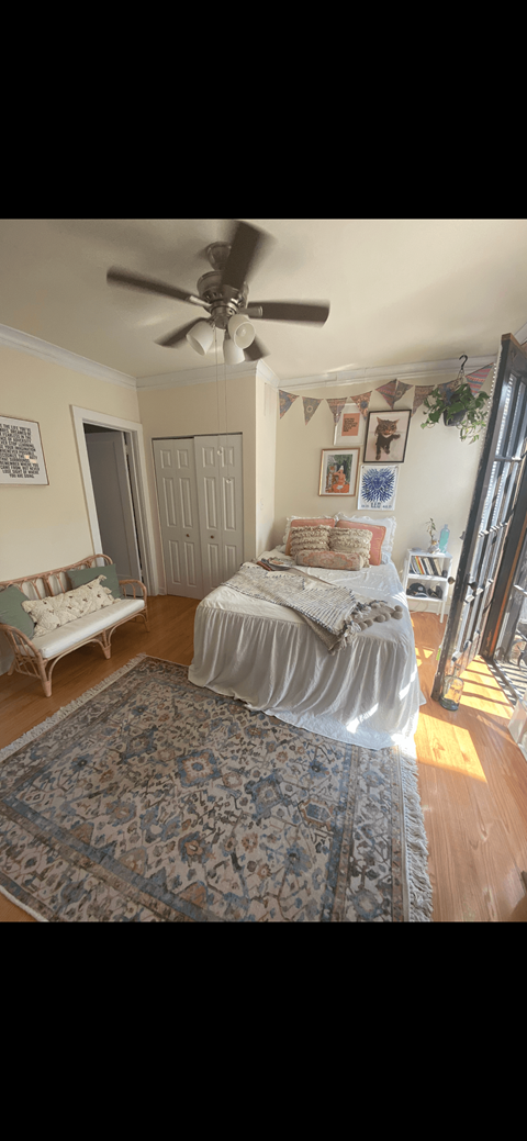 a bedroom with a bed and a ceiling fan