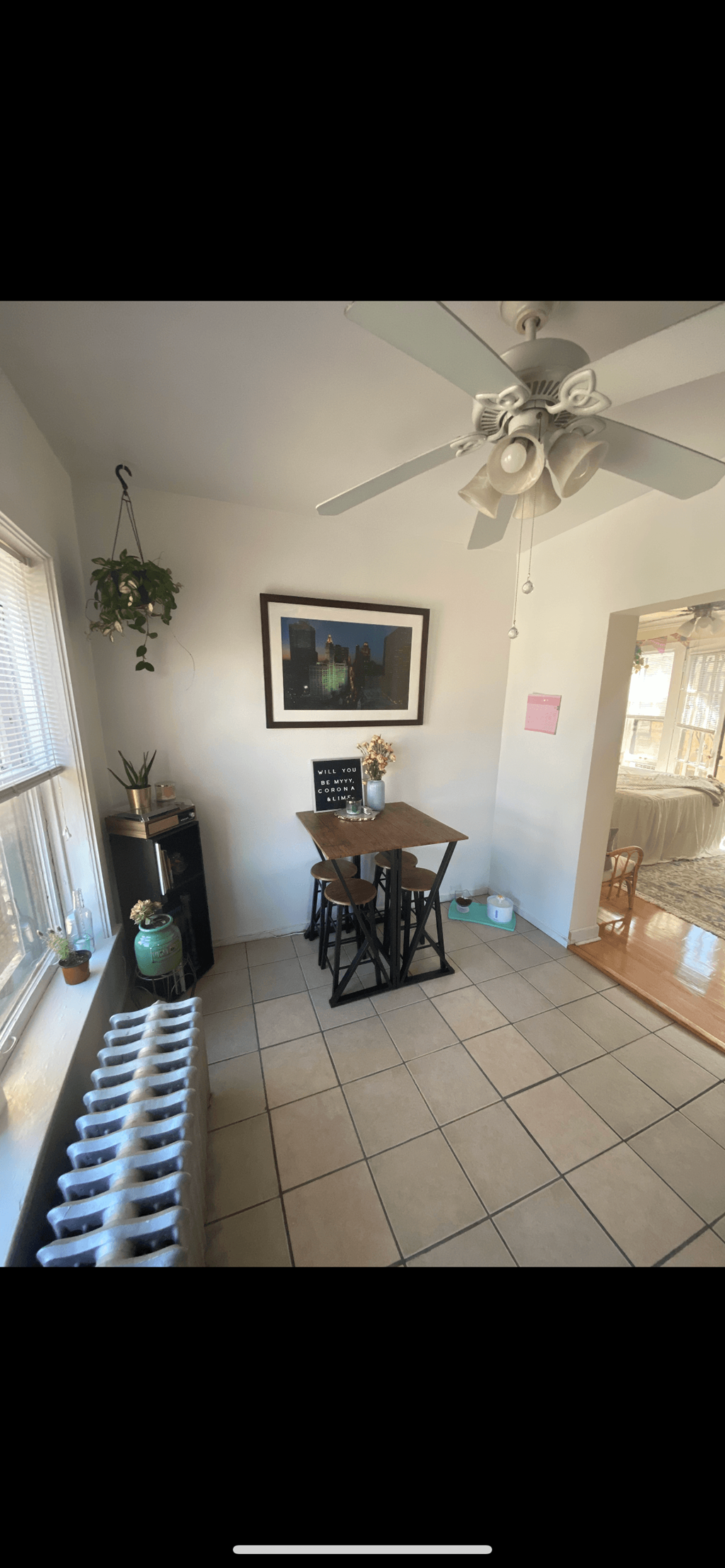 a dining room with a table and a ceiling fan