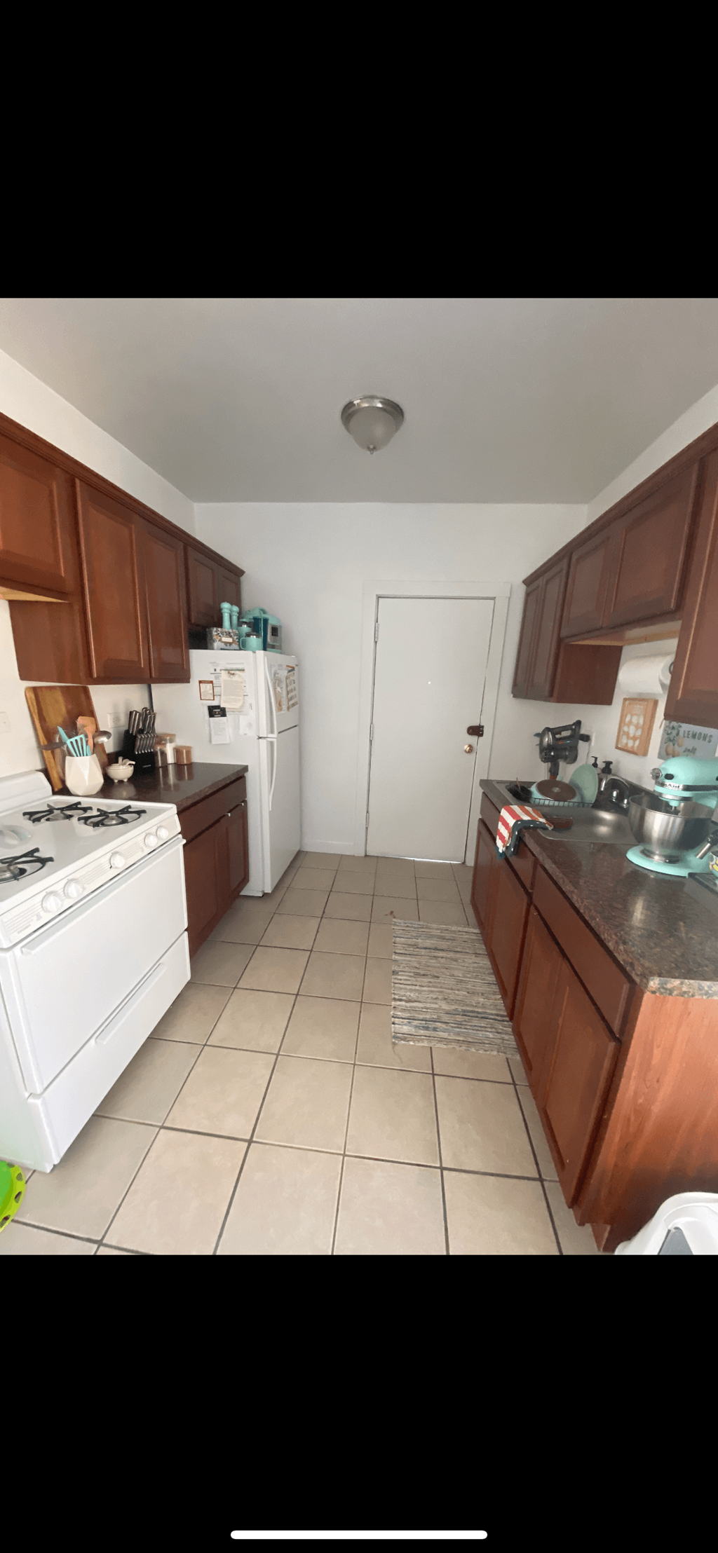 a kitchen with a stove refrigerator and a sink