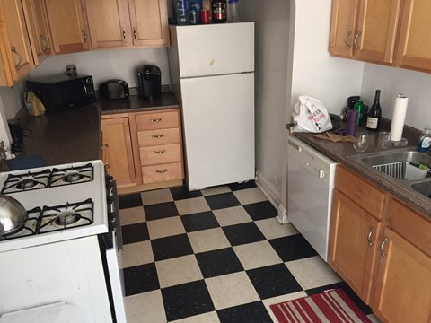 a kitchen with a checkered floor and a white refrigerator