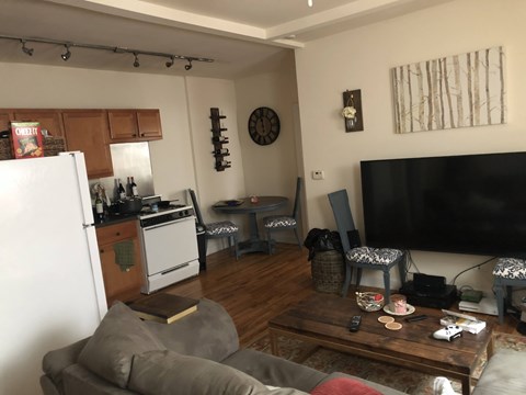 A living room with a grey couch and a wooden coffee table.