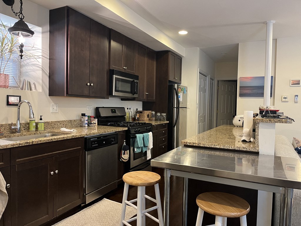 a kitchen with stainless steel counter tops and black appliances