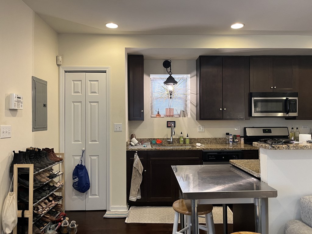 a kitchen with a island and a door to a closet