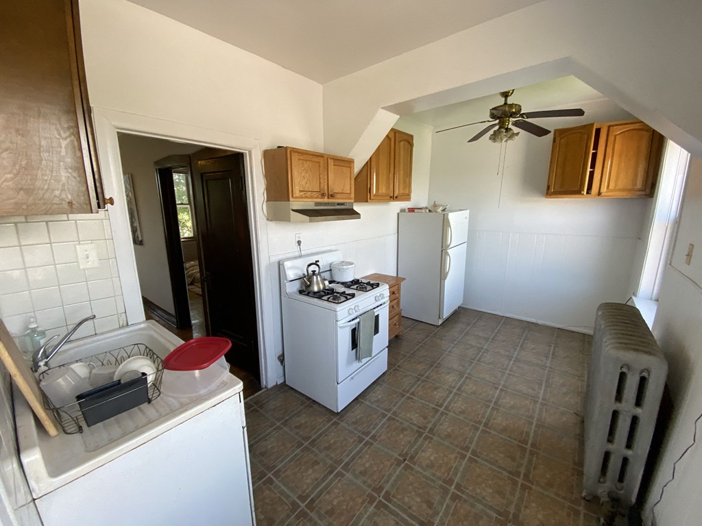 a kitchen with a stove refrigerator and a sink