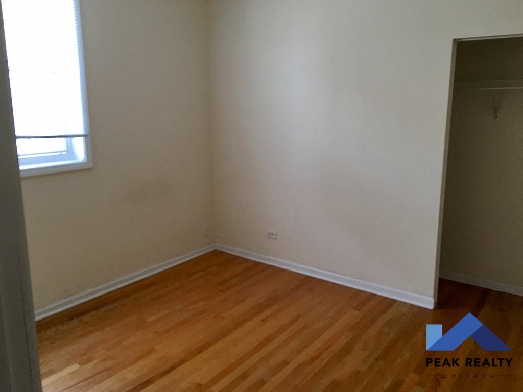 an empty room with wooden floors and a closet