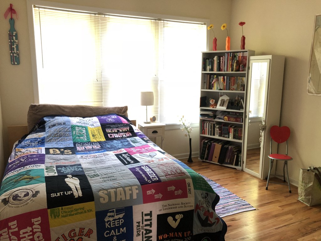 a bedroom with a bed with a quilt on it